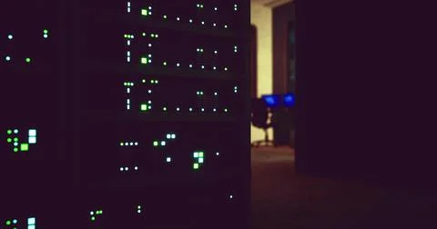 Data servers illuminated in a dimly lit office environment at night Stock Illustration