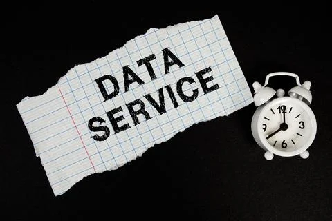 Data Service text written on paper with alarm clock on black background Stock Photos