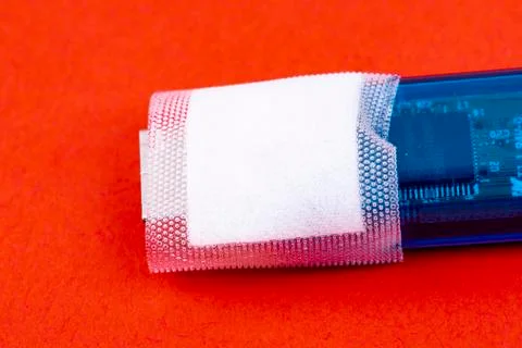 Data stick with plaster in close-up Stock Photos