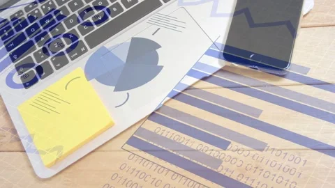 On data sync, laptop with printed charts and phone showing rotating overlays, Stock Footage 334744251