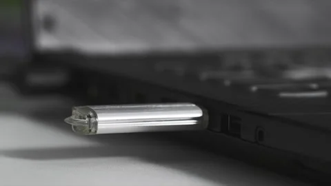 Data transfer, flash drive is plugged into USB connector on computer, light is Stock Footage 240859715