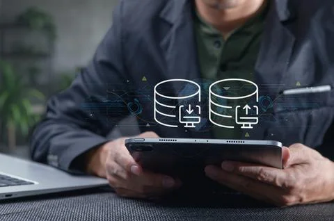Data Transfer Network Concept with Person Using Tablet in Office Setting Stock Photos