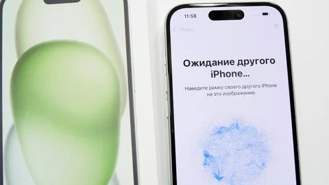 Data transferring from old iPhone to new iPhone 15 closeup. Updating to a new Stock Photos