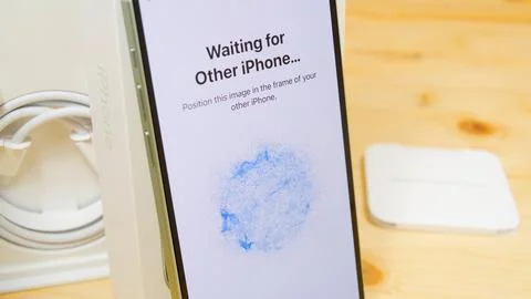 Data transferring from old iPhone to new iPhone 15 closeup. Updating to a new Stock Photos