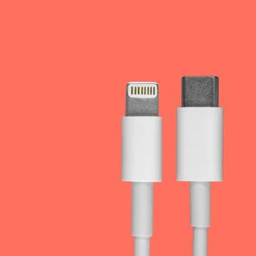 Data usb lightning cable lugs for a smartphone on a coral background, a mocku Stock Photos