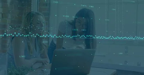 Data visualization image over two women working on laptop in office Stock Photos