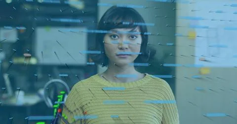 Data visualization image over woman in yellow sweater looking forward Foto stock