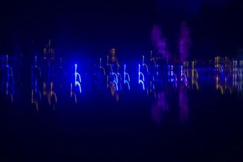 Data visualization, neon blue and purple long exposure lights in night darkness Stock Photos