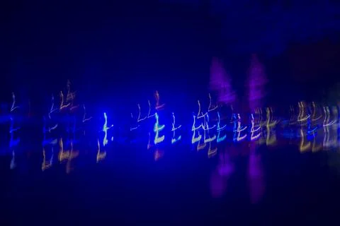 Data visualization, neon blue and purple long exposure lights in night darkness Stock Photos