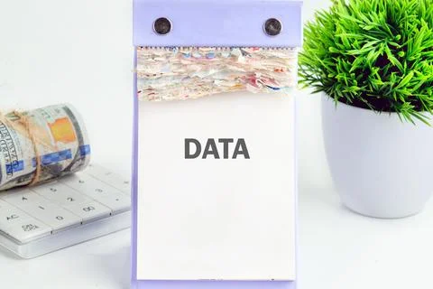 DATA word written on a desktop calendar on a white background. Financial Stock Photos