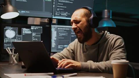Database admin having fun listening to music on headset Stock Photos