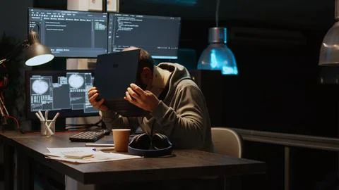 Database admin with neck collar foam working on code developing Stock Photos