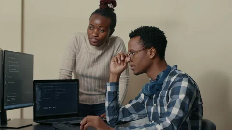 Database developer removing glasses while explaining algorithm to colleague Video stock 168234793