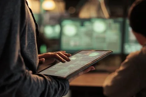 Database illegal access, hacker using spyware on digital tablet Fotos de archivo