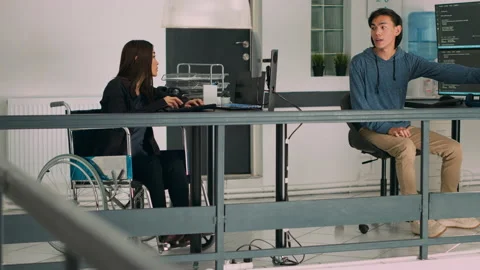 Database programer with physical disability writing code on computer screen Stock Footage 227614290