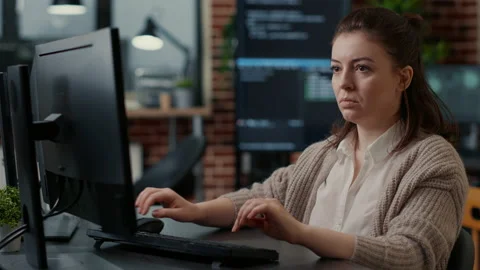 Database programer working focused looking at computer screen while typing Stock Footage 168252911