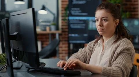 Database programer working focused looking at computer screen while typing 스톡 사진