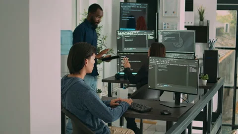 Database programer writing code on computer in software company office Stock Footage 220380238