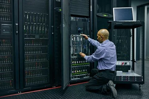 Database, software and a man engineer in a server room for cybersecurity Stockfoto's
