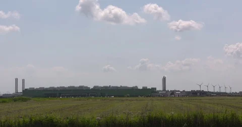 Datacenter Microsoft in Dutch polder landscape, wind turbines at horizon 動画素材 77998042