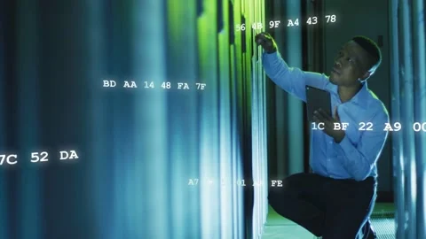 Datacenter tech kneeling, tapping tab and scanning rack, checking servers while Stock Footage 332704750