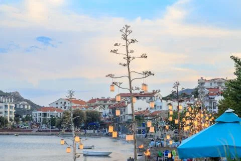 Datca beach with lantern lights on trees during dusk in Datca, Turkey Stock Photos