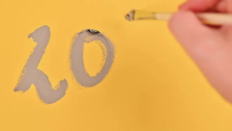 Date 2021, painted with a brush in gray paints on a yellow background. Color pat Stock Footage 145226413