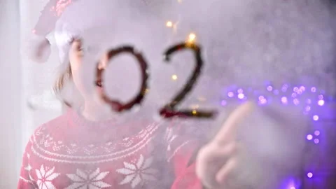 Date 2021 on a snowy window. New year and christmas concept. Blurred image. Stock Footage 144019680