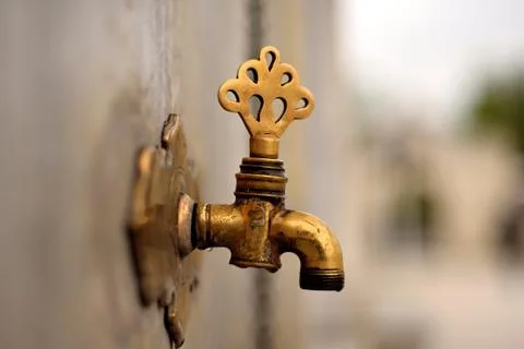 Date of ablution tap made ​​of brass Stock Photos