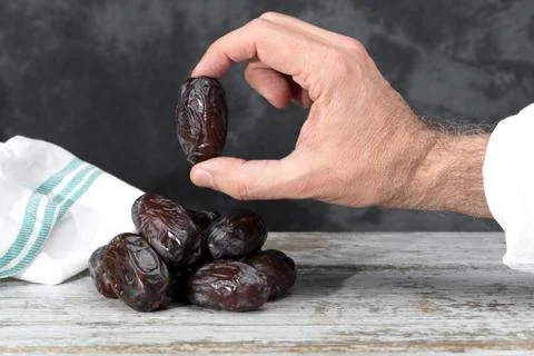 Date between the fingers Stock Photos