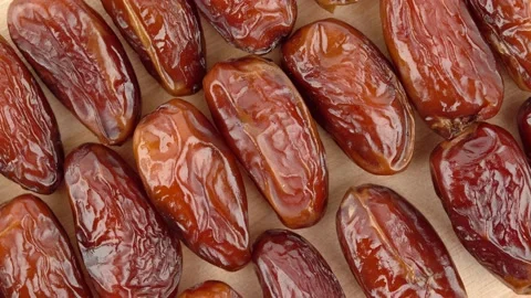 Date fruit laid out on board, rotation. Stock Footage 136040528