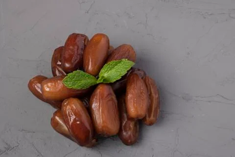 Date fruit Medjool with mint leaf on concrete background ripe and dried Stock Photos