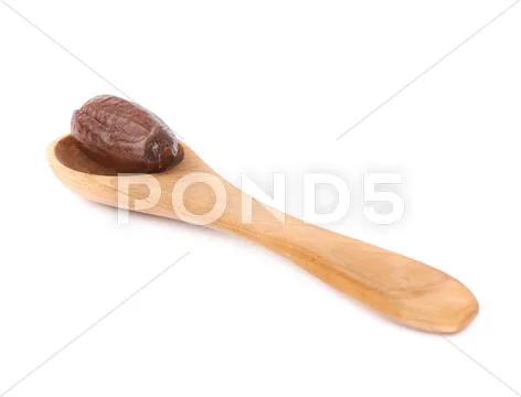 Date fruit in wooden spoon over white isolated background surface Stock Photos