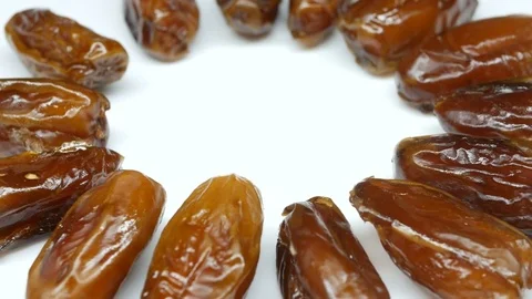 Date Fruits rotating in a circle on a white background, close-up Stock Footage 82639626