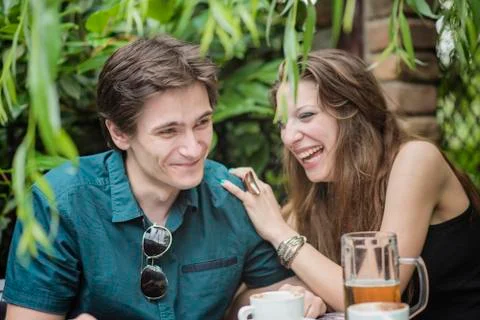 Date going well, man and woman chatting over drinks Stock Photos
