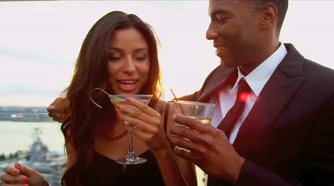 Date of Hispanic woman and African American man at cocktail party Stock Footage