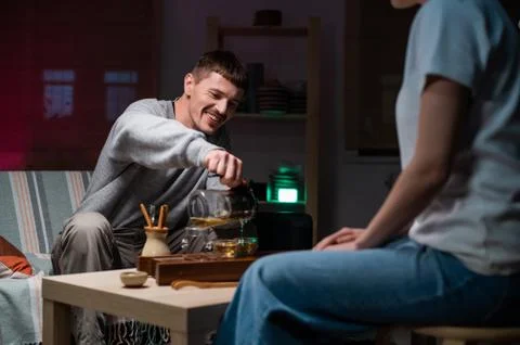 Date in an intimate setting of a tea house. A man and a woman drink fragrant tea Stock Photos