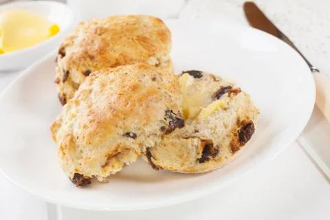 Date scones with butter Stock Photos