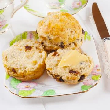 Date scones with butter Stock Photos