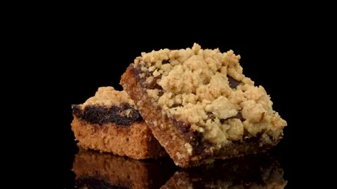 Date Squares Rotating on Turntable on Dark Reflective Background Stock Footage 330514643