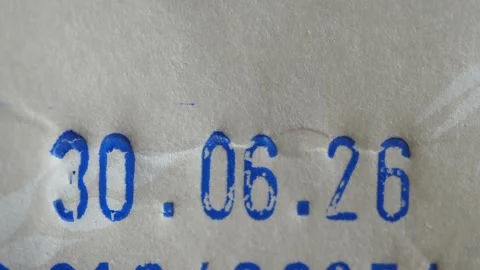 Date stamp expiration date 30 06 26 imprinted on white paper packaging mate.. Stock Footage 331905226