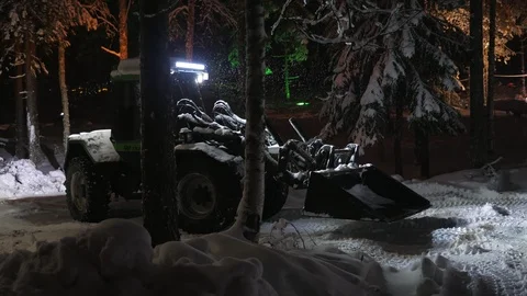 Up-to-date tractor with a big blaze cleaning wood in Finland at night in winter Video stock 122818253