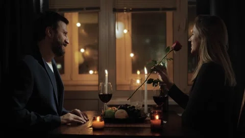 Date, Valentines Day, first date. Man gives one rose to woman during romantic Stock-Footage 256416278