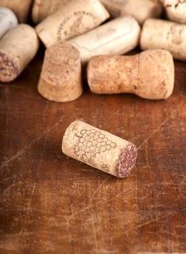 Dated wine bottle corks on the wooden background. Stock Photos