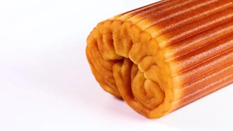 Datemaki (egg roll fish cake) on white background rotating Stock Footage 321622689