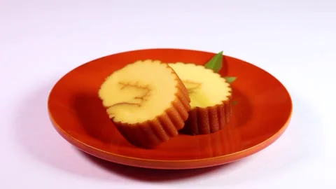 Datemaki (egg roll fish cake)on a plate rotating Stock Footage 321622714