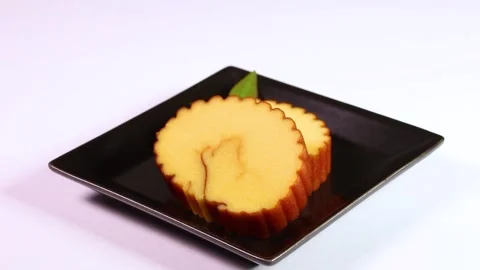 Datemaki (egg roll fish cake) on a plate rotating Video stock 322040168