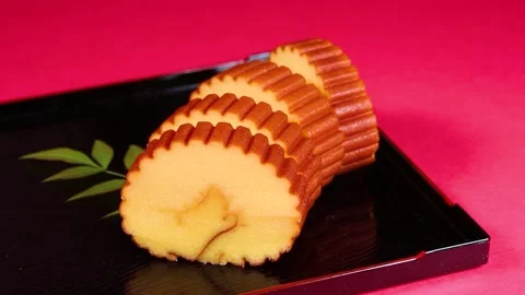 Datemaki (egg roll fish cake) on a plate rotating Stock Footage 322040174