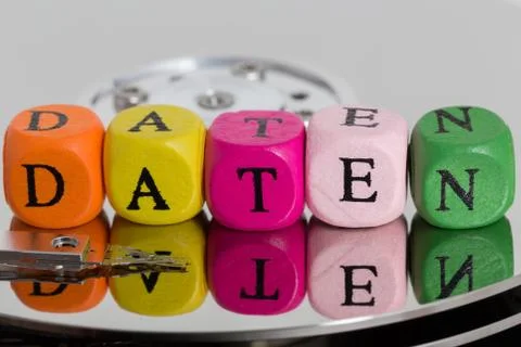 Daten (in german Data) letter cube on hard disk concept Stock Photos