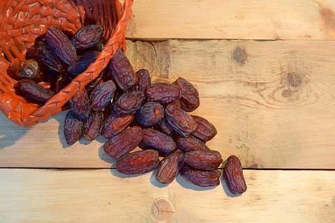 Dates and basket on the open table. Stock Photos